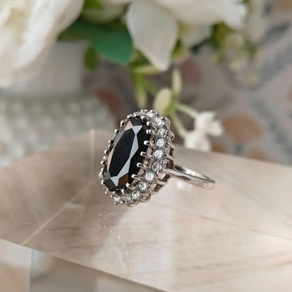 Silver tone oval black glass halo ring with white rhinestones